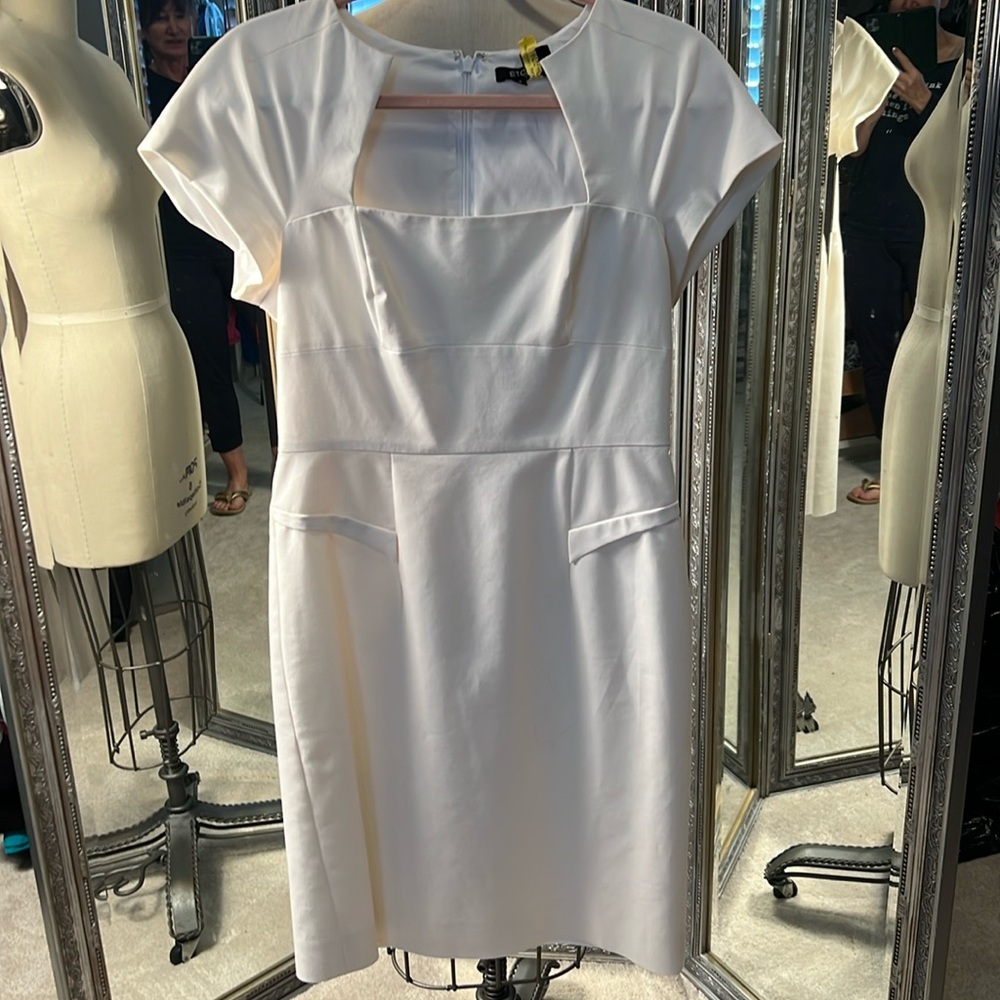 creamy white dress. Short sleeve, lots of detail going on at waist  and bust.
